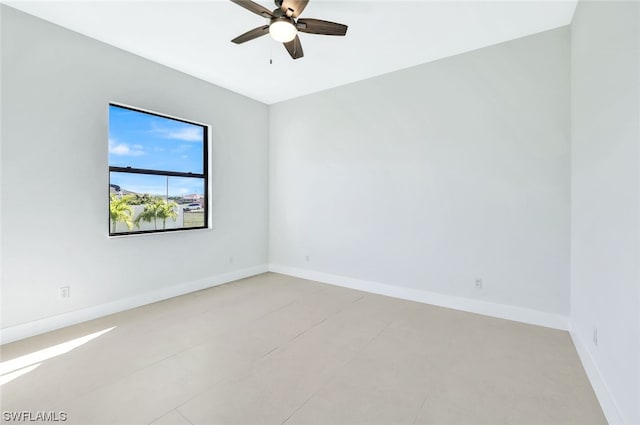 tiled spare room with ceiling fan