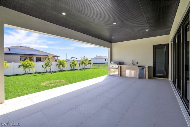 view of patio / terrace with a grill, sink, and exterior kitchen