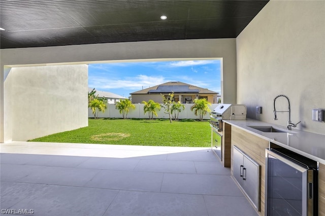 view of terrace featuring grilling area, sink, and exterior kitchen