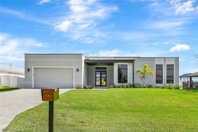 view of front of house with a front yard and a garage