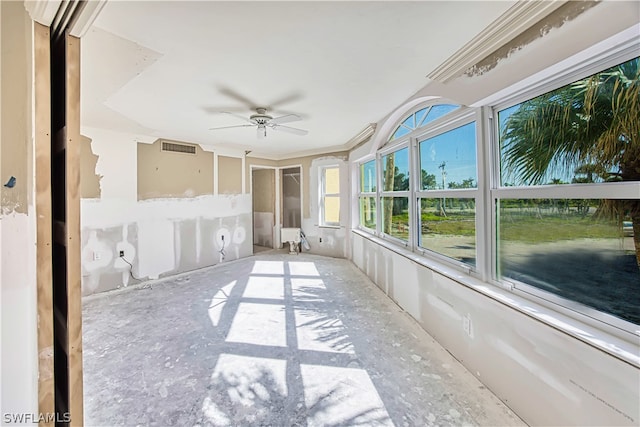 unfurnished sunroom featuring ceiling fan