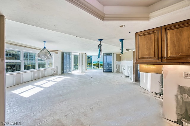 unfurnished living room with ornamental molding and light tile flooring