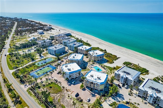 birds eye view of property with a beach view and a water view