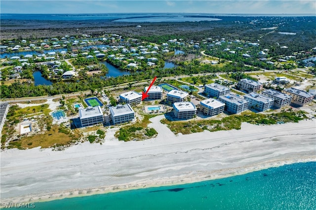 drone / aerial view with a water view and a view of the beach