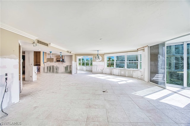 interior space with crown molding and light tile floors