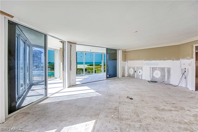 unfurnished living room with tile floors and expansive windows