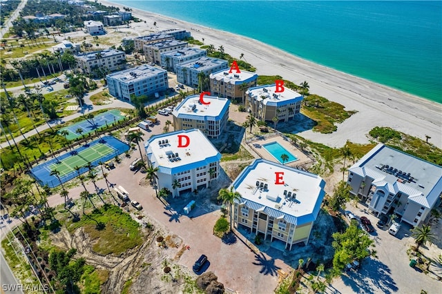 birds eye view of property featuring a view of the beach and a water view