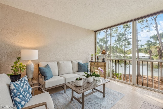 sunroom featuring a water view