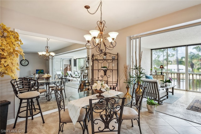 dining room featuring an inviting chandelier and light tile flooring