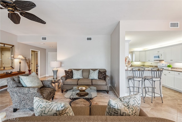 tiled living room featuring ceiling fan