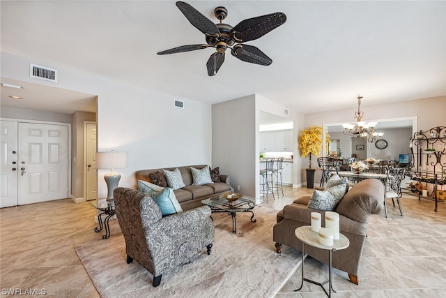 living room with light tile flooring and ceiling fan with notable chandelier