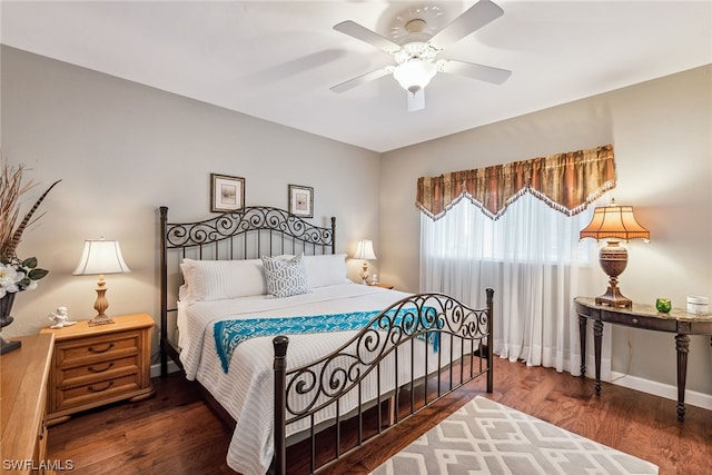 bedroom with dark hardwood / wood-style floors and ceiling fan