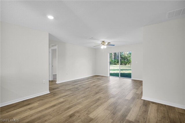 unfurnished room with hardwood / wood-style floors and ceiling fan