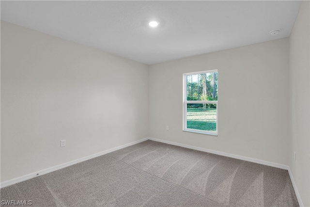 unfurnished room with light carpet