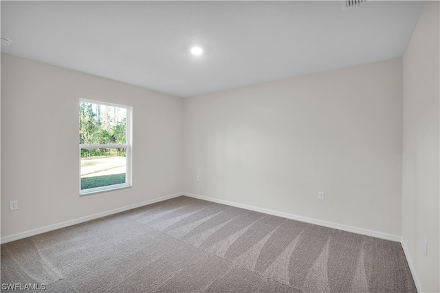 empty room featuring light carpet