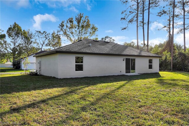 rear view of house with a yard