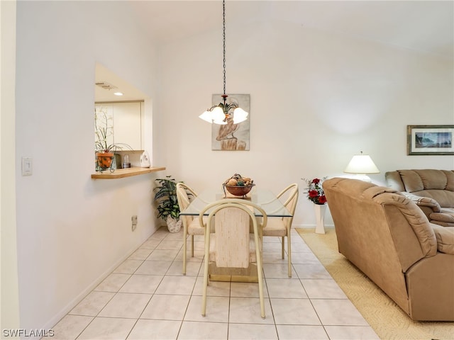 dining area with light tile patterned floors and a notable chandelier