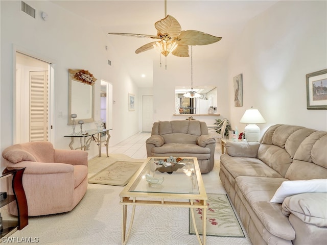 living room with ceiling fan and high vaulted ceiling