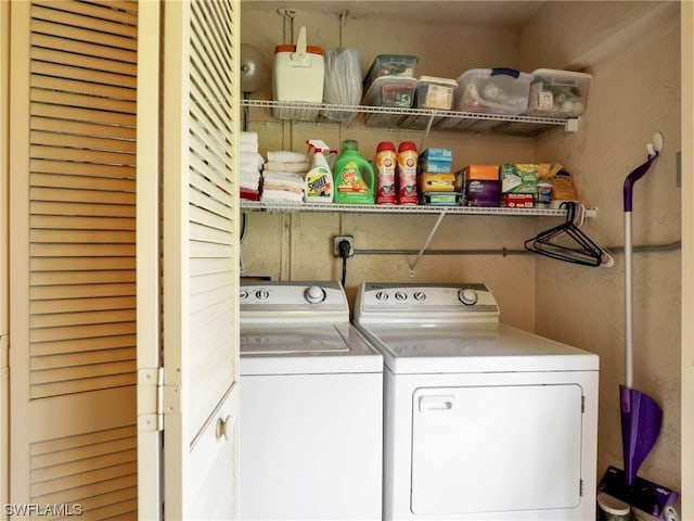 clothes washing area featuring separate washer and dryer