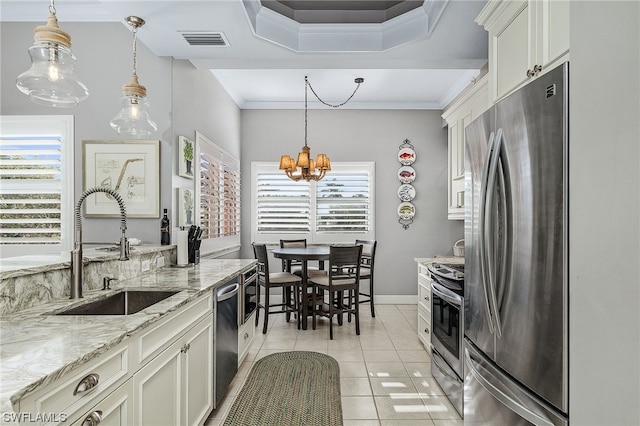 kitchen with white cabinets, pendant lighting, stainless steel appliances, and sink