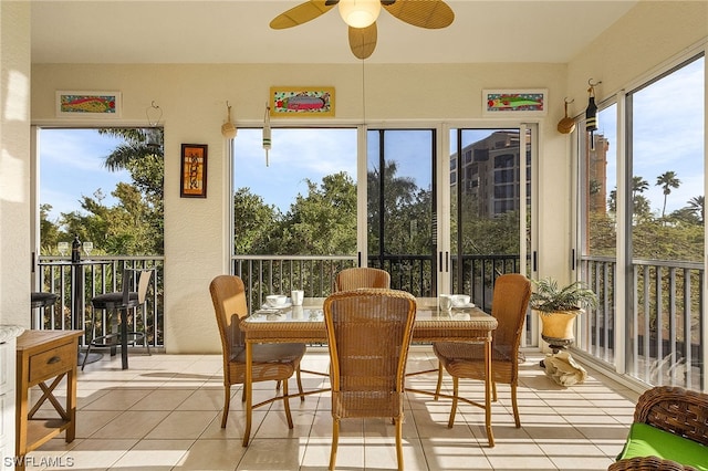 sunroom / solarium featuring ceiling fan