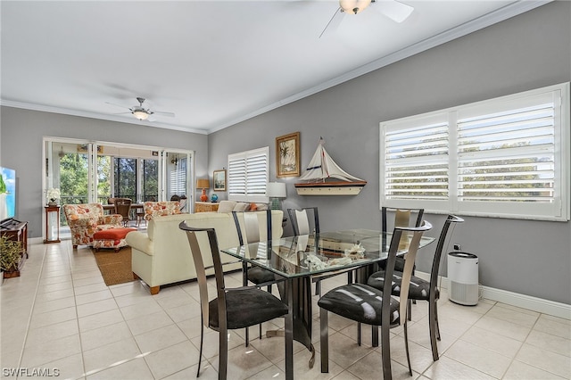 tiled dining space with ceiling fan and ornamental molding