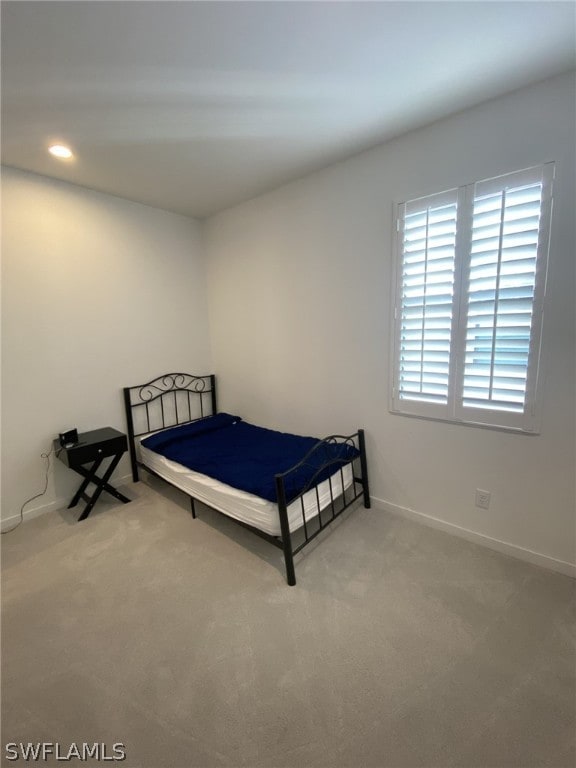 bedroom with light colored carpet