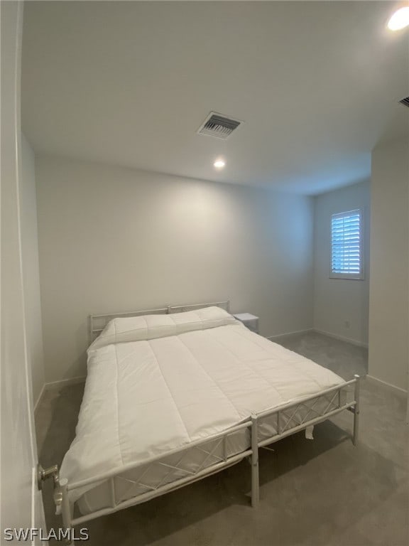 bedroom featuring dark carpet