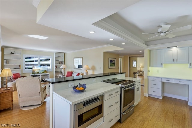 kitchen featuring white cabinetry, light hardwood / wood-style floors, ceiling fan, and stainless steel appliances