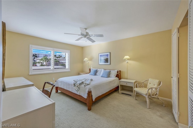 carpeted bedroom with a closet and ceiling fan