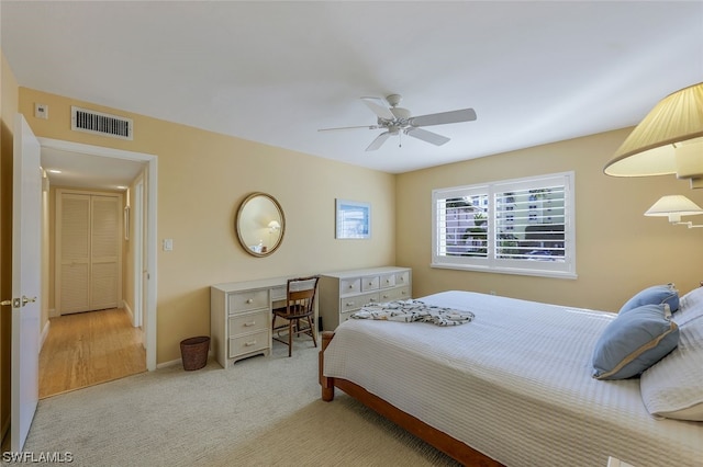 bedroom with light colored carpet and ceiling fan