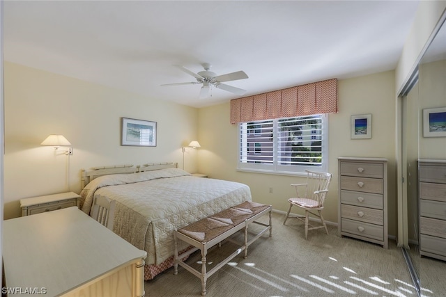 bedroom featuring light colored carpet and ceiling fan