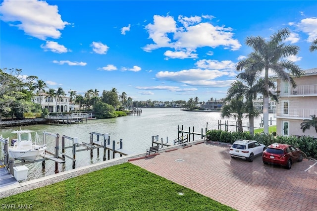 view of dock featuring a water view and a yard