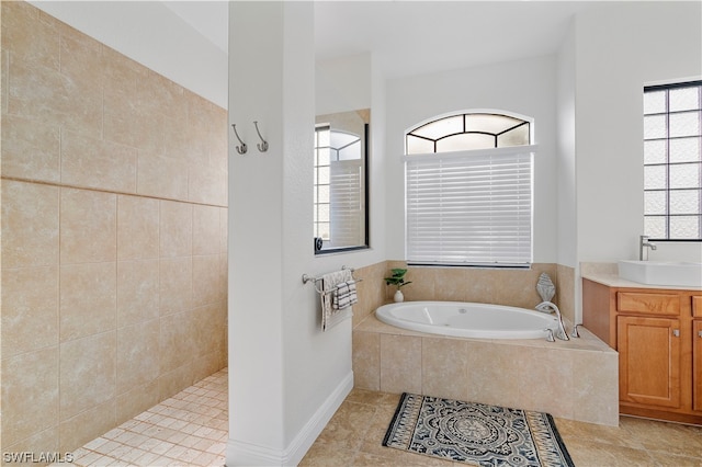 bathroom featuring plenty of natural light, tile floors, and vanity