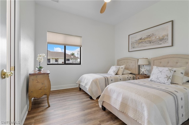 bedroom with light hardwood / wood-style floors and ceiling fan