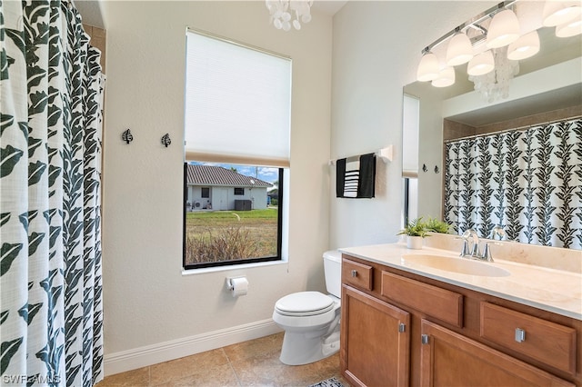 bathroom featuring toilet, tile floors, and vanity with extensive cabinet space