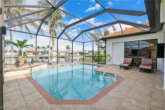 view of pool with glass enclosure and a patio