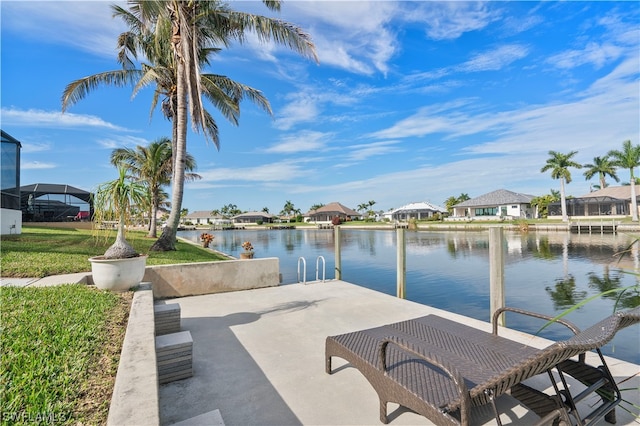 view of patio with a water view and a boat dock