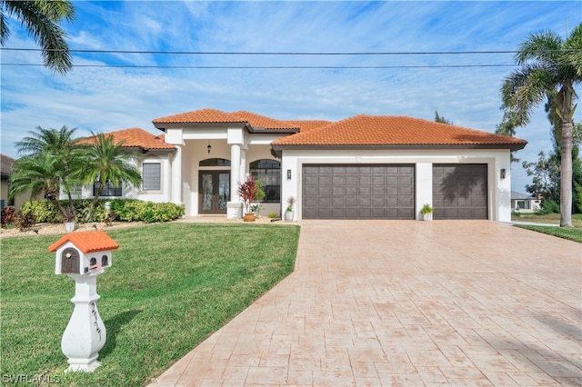 mediterranean / spanish-style house featuring a front lawn and a garage