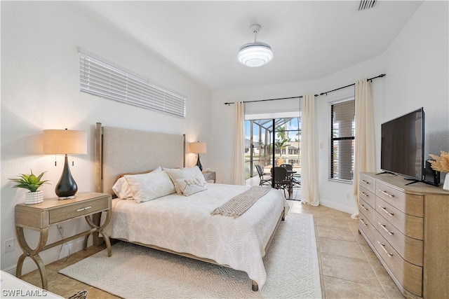 bedroom with light tile floors and access to exterior