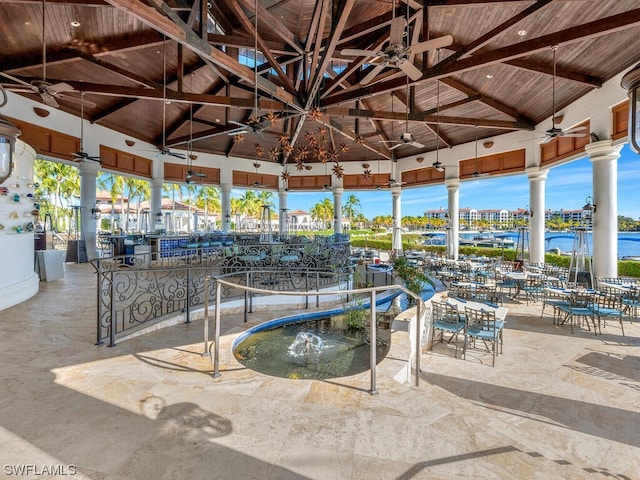 view of swimming pool with a patio, a gazebo, and a water view