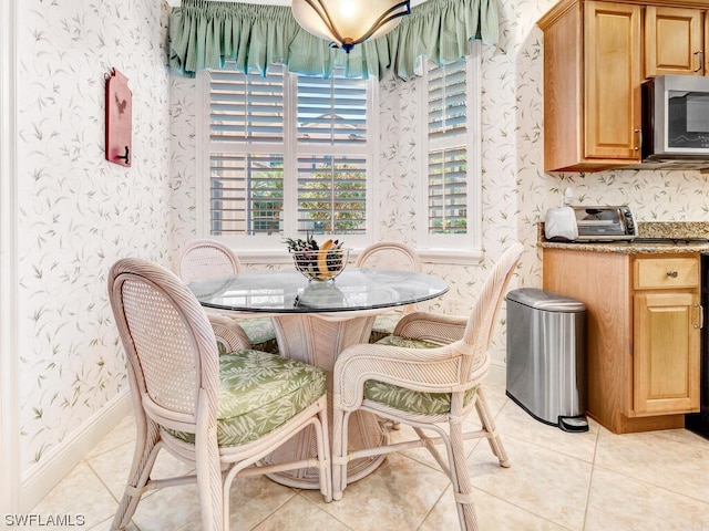 dining space featuring light tile patterned flooring