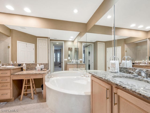 bathroom featuring shower with separate bathtub, tile patterned flooring, and vanity