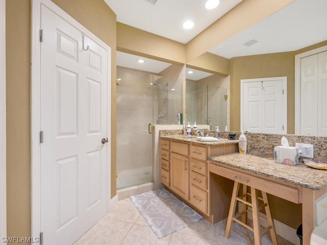 bathroom with vanity, an enclosed shower, and tile patterned floors