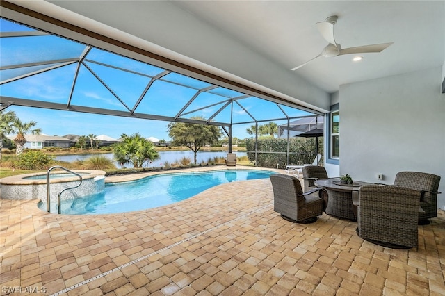 view of pool with a patio, glass enclosure, and ceiling fan