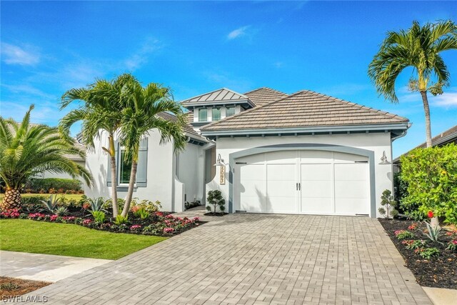 view of front facade featuring a garage and a front lawn