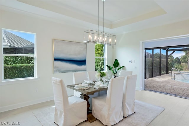 dining space featuring a chandelier and a tray ceiling