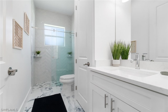 bathroom featuring toilet, marble finish floor, vanity, and a stall shower