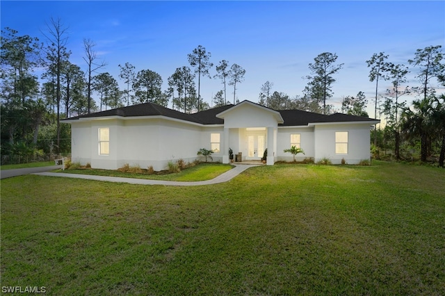 ranch-style house featuring french doors and a front yard