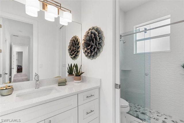 full bathroom with vanity, a shower stall, and toilet